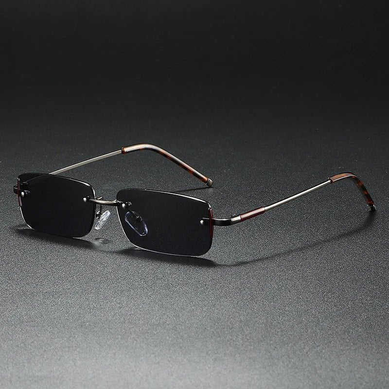 Lightweight rimless rectangular sunglasses with sleek gradient lenses & elegant gold hardware.