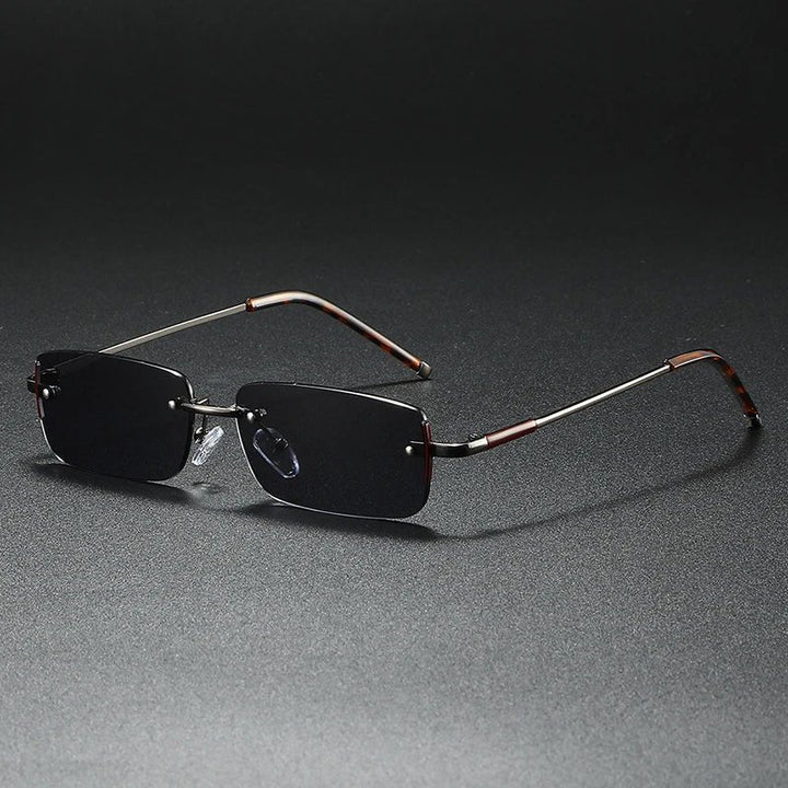 Lightweight rimless rectangular sunglasses with sleek gradient lenses & elegant gold hardware.