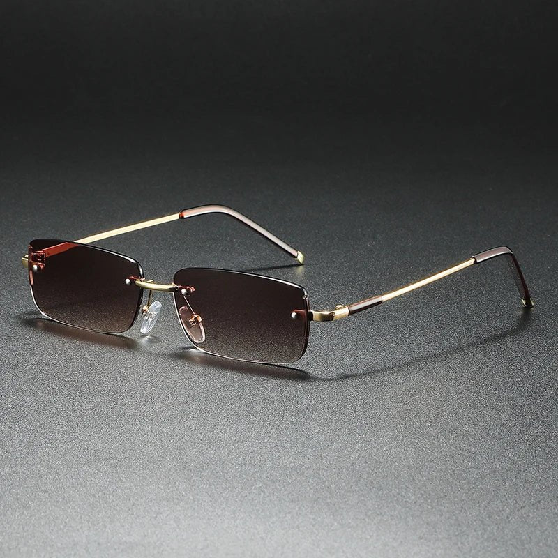 Fashionable unisex rectangular rimless eyewear featuring gradient lenses & chic gold accents.