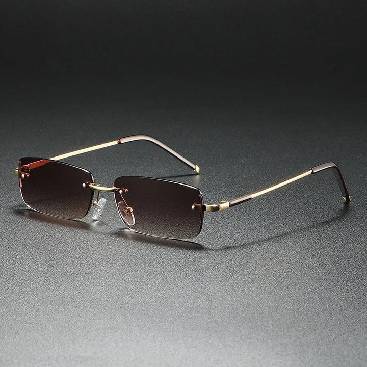 Fashionable unisex rectangular rimless eyewear featuring gradient lenses & chic gold accents.