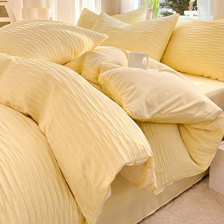 Unisex bedding set featuring a soft pink solid color seersucker texture, offering wrinkle-resistant comfort.