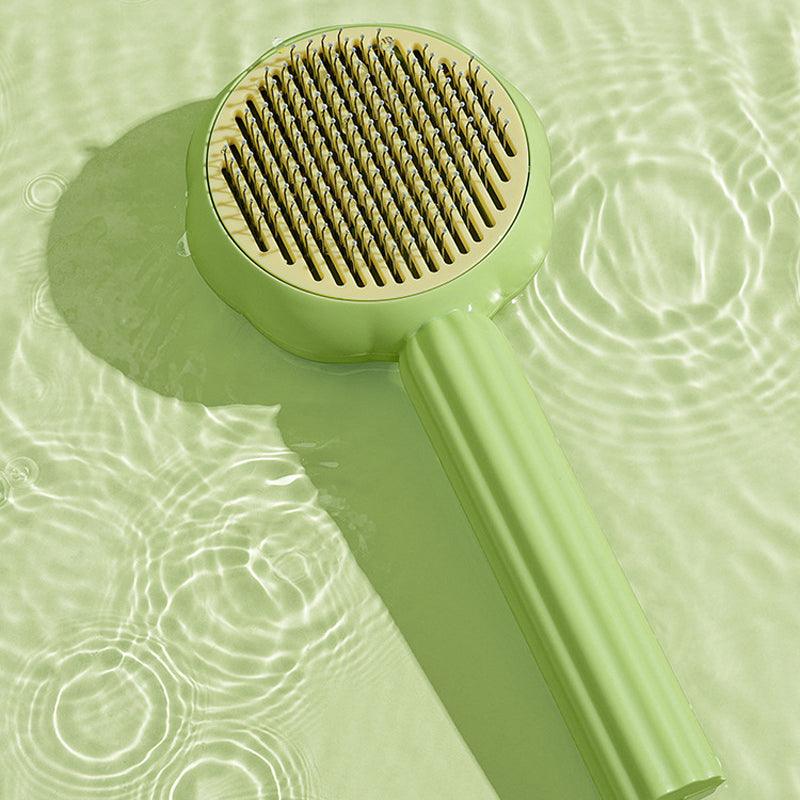 Self-cleaning pet brush for dogs & cats, demonstrating easy fur release after grooming