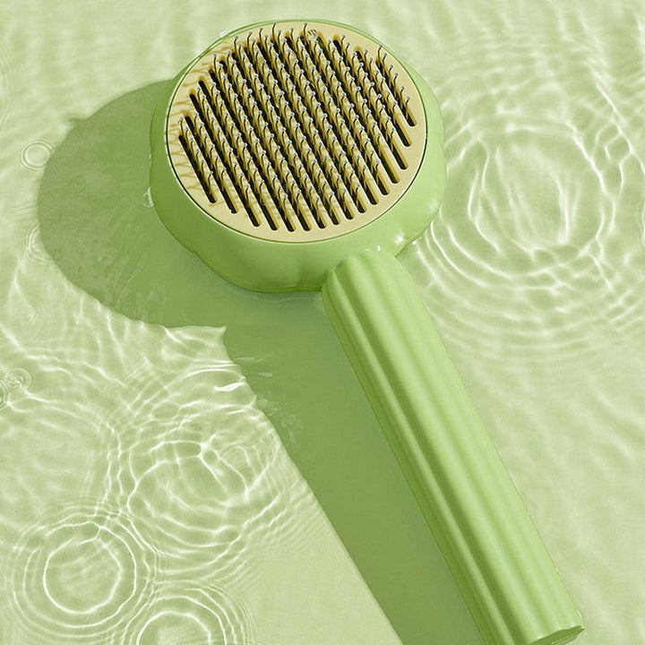 Self-cleaning pet brush for dogs & cats, demonstrating easy fur release after grooming