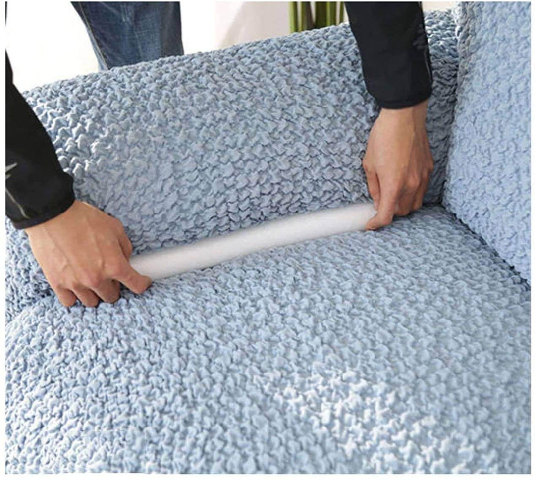 Close-up of white unisex sofa cover grippers, foam sticks preventing couch cover slippage, home decor
