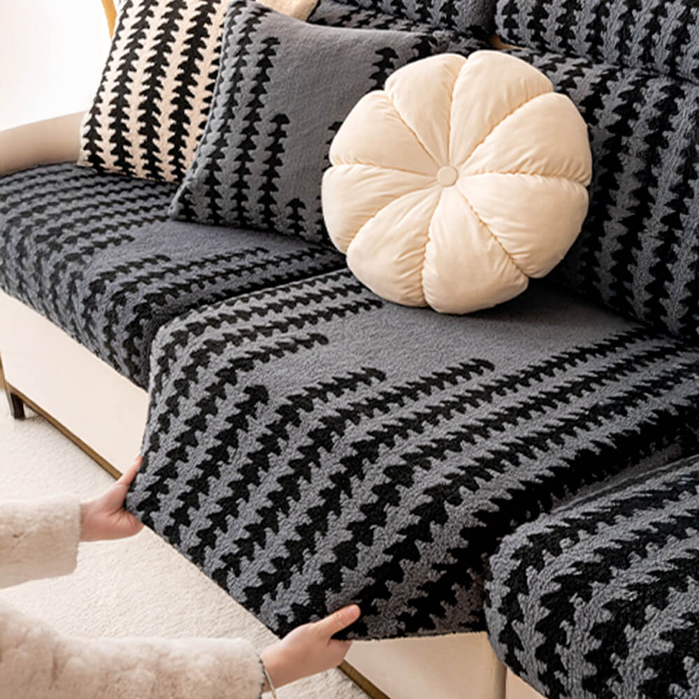 Close-up of herringbone pattern on a gray stretch sofa slipcover, cozy home essential