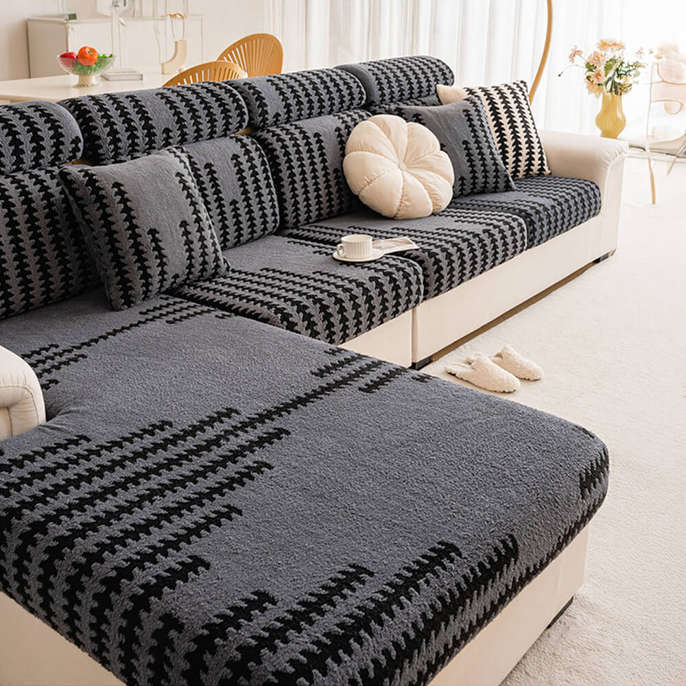 Full view of a living room with a cream stretch herringbone sofa slipcover protecting furniture