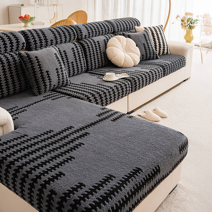 Full view of a living room with a cream stretch herringbone sofa slipcover protecting furniture