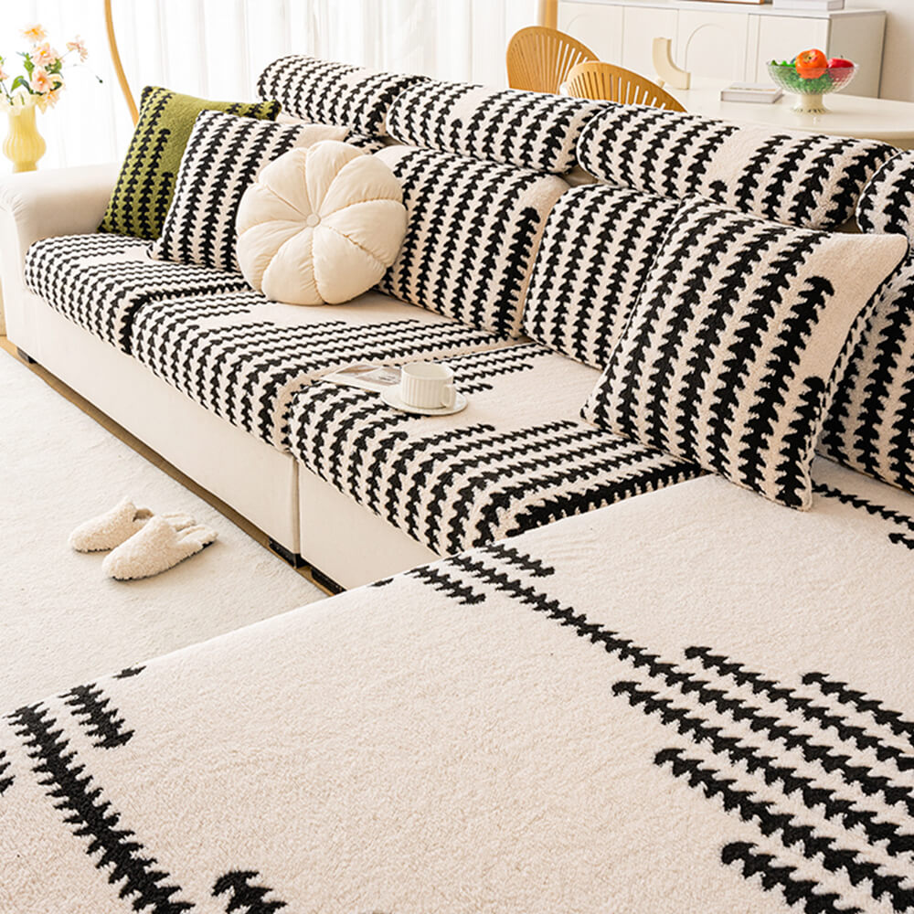 Modern gray stretch herringbone couch cover draped over a sofa, stylish furniture protector