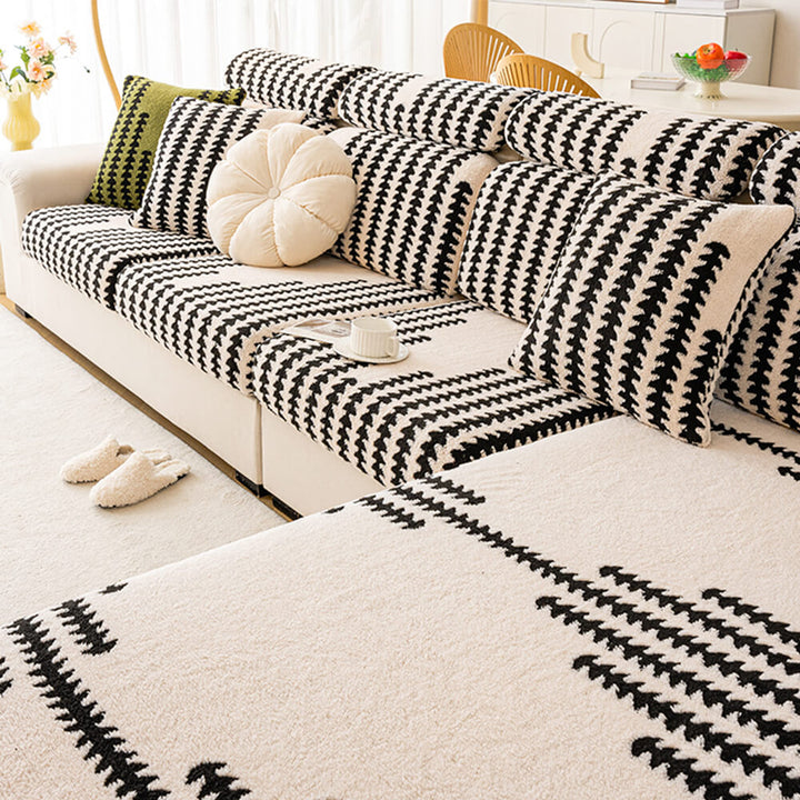 Modern gray stretch herringbone couch cover draped over a sofa, stylish furniture protector