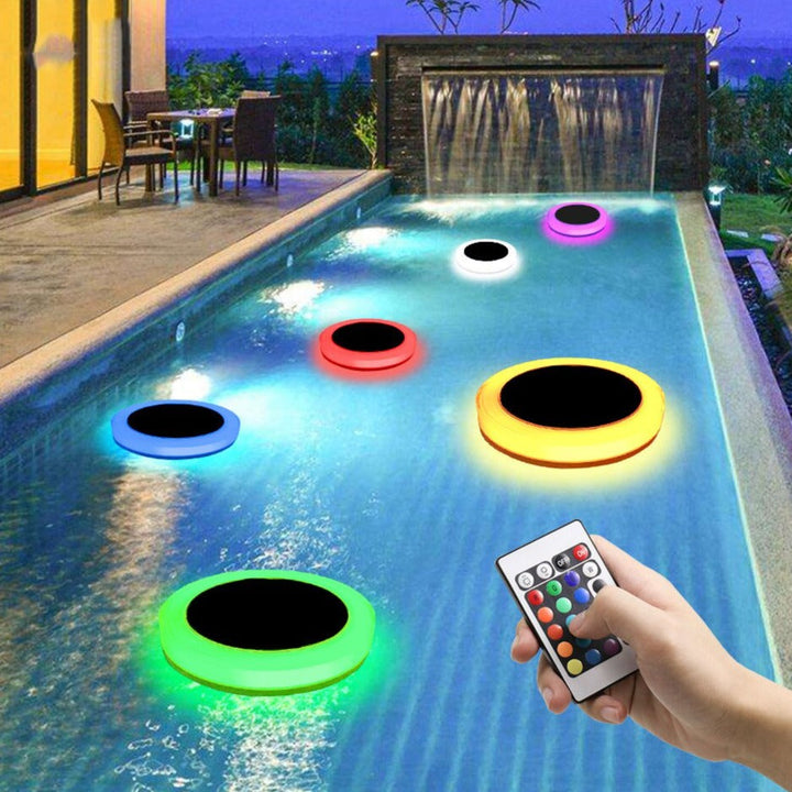 Unisex solar powered RGB floating pool light illuminating a pool at night with vibrant colors