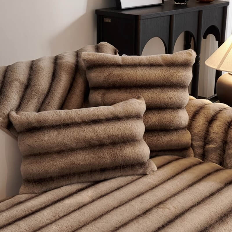 Close-up of striped faux rabbit fur texture on a sofa protector, soft and inviting