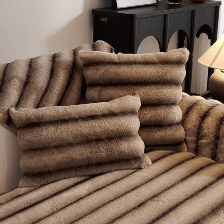 Close-up of striped faux rabbit fur texture on a sofa protector, soft and inviting