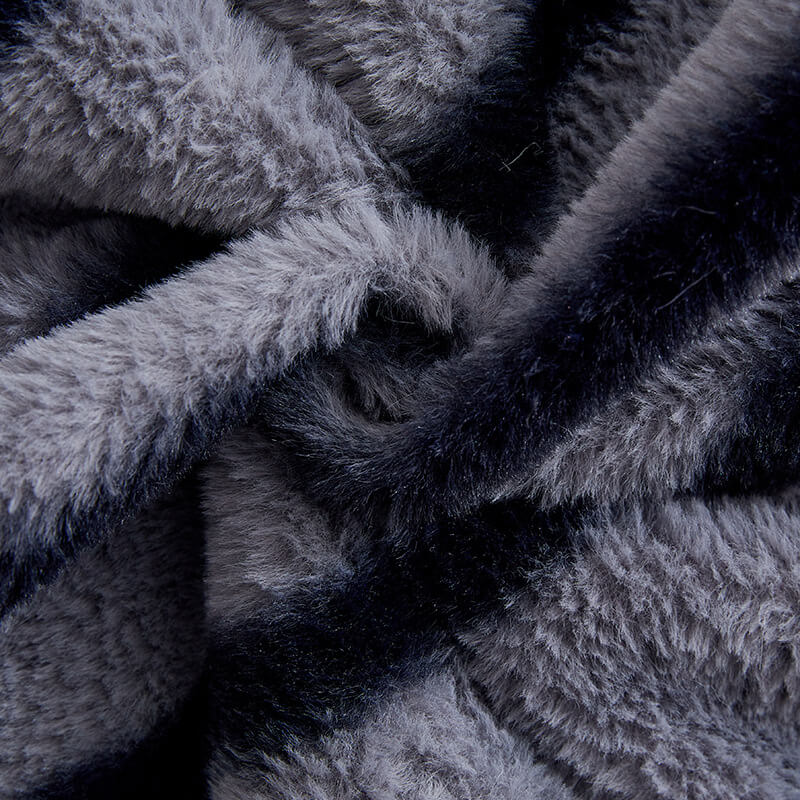 Detail of the non-slip backing on a striped faux fur sofa protector for secure fit