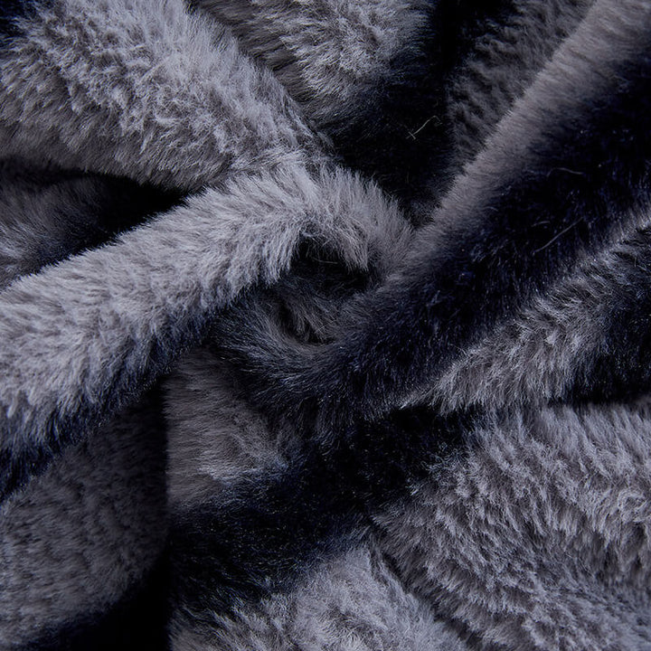 Detail of the non-slip backing on a striped faux fur sofa protector for secure fit