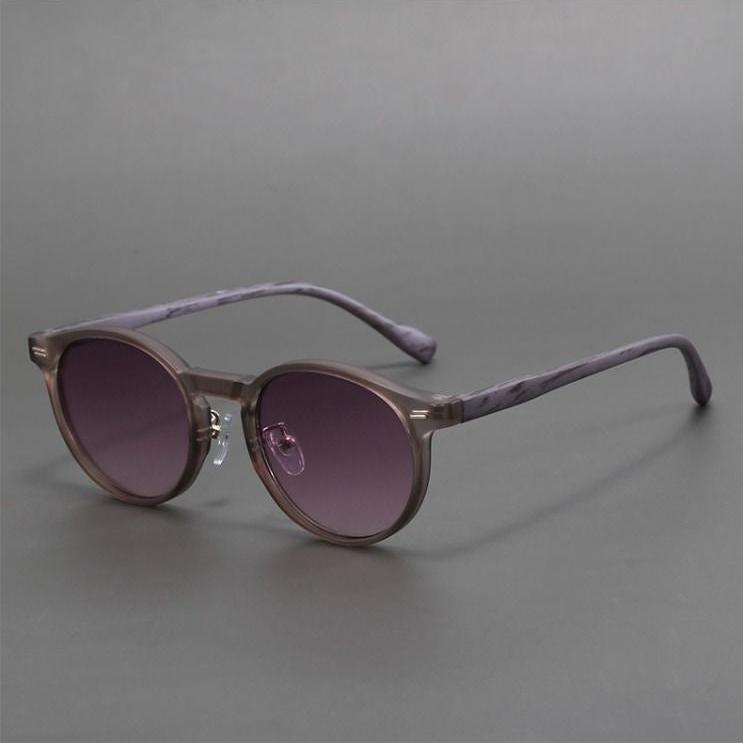 Sleek unisex round sunglasses with dark lenses, offering superior UV protection. Trendy and durable eyewear for summer.