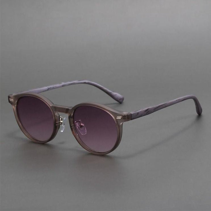 Sleek unisex round sunglasses with dark lenses, offering superior UV protection. Trendy and durable eyewear for summer.
