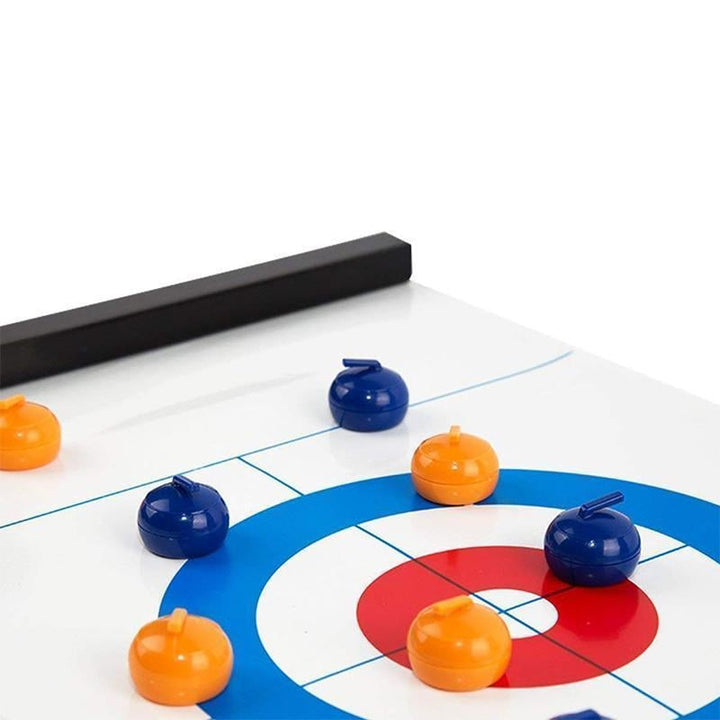 Adults enjoying a lively party game with the portable tabletop curling set.