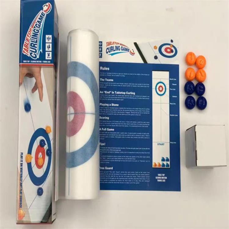 Close-up of curling stones sliding on the tabletop game board during intense play.