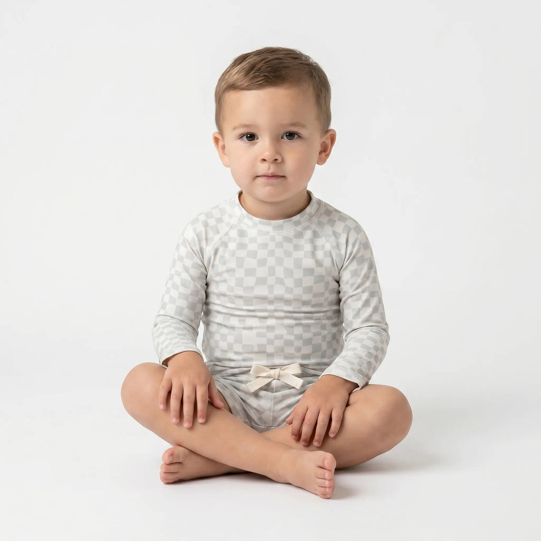 Kids' long sleeve rash guard swimwear set, offering UPF 50+ sun protection for toddlers at the beach.