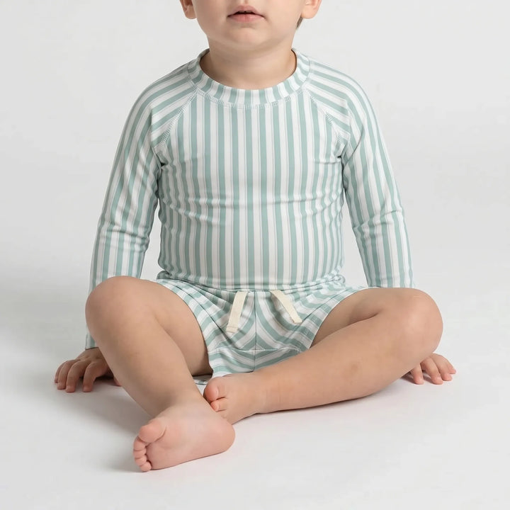 Back view of a stylish long sleeve rash guard and shorts toddler swimwear set for sun-safe kids' beach fun.