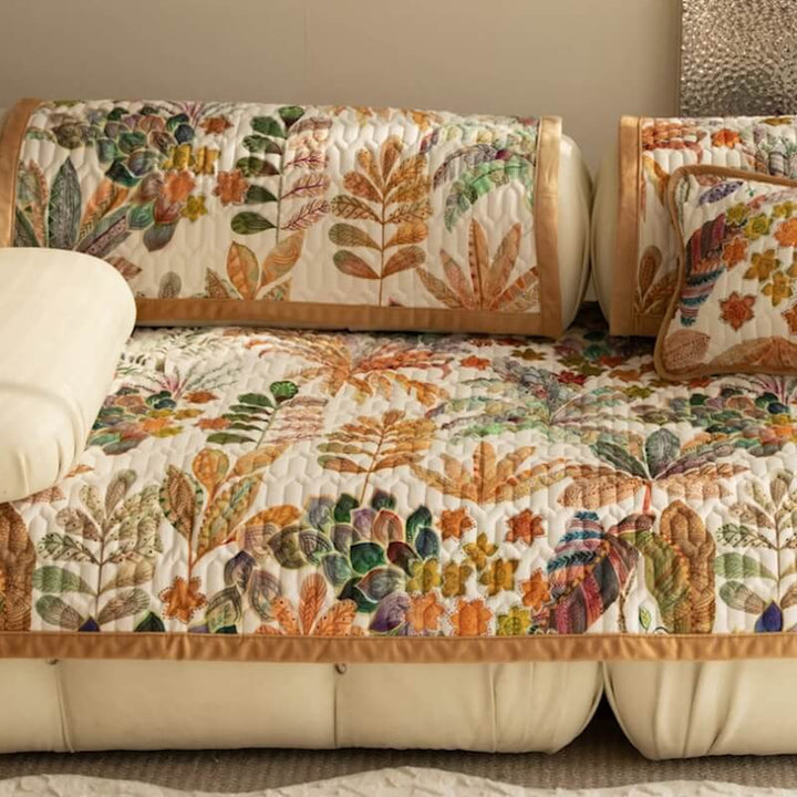 Full view of a couch draped with a colorful tropical pattern sofa protector