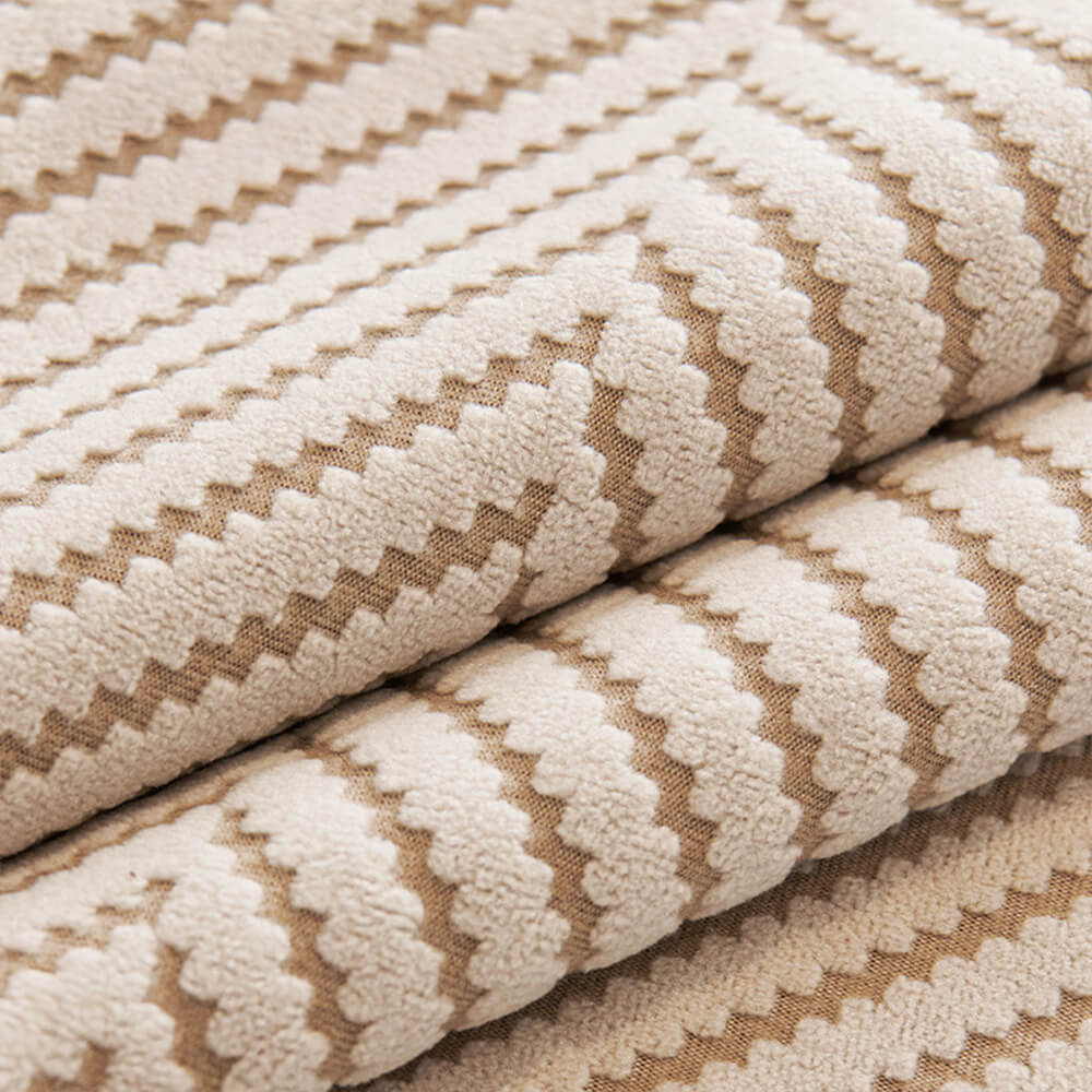 Folded unisex two-tone herringbone fleece couch cover, highlighting its soft material