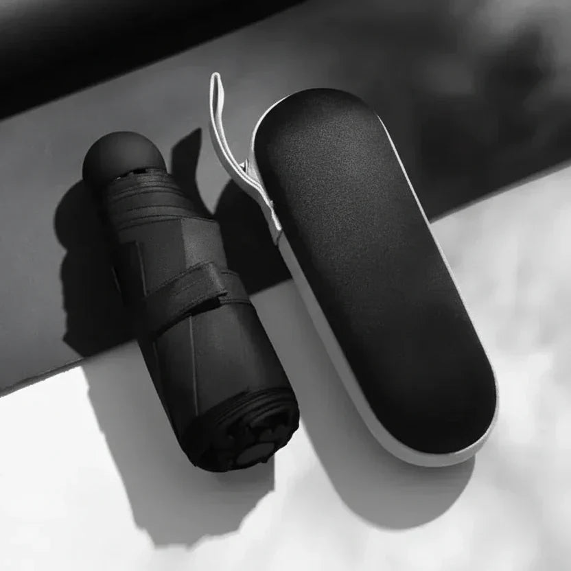 Essential travel accessory: a compact, lightweight umbrella offering reliable rain gear functionality.