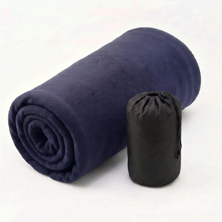 Folded ultralight fleece sleeping bag liner, showcasing its compact size for easy travel packing.