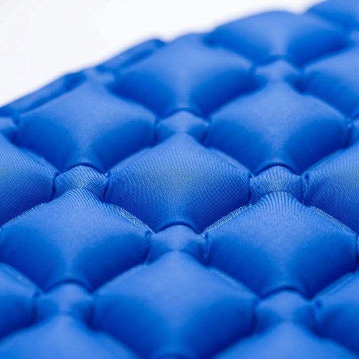 Compact, rolled-up ultralight camping sleeping pad, ideal portable gear for backpacking, hiking, and outdoor adventures.