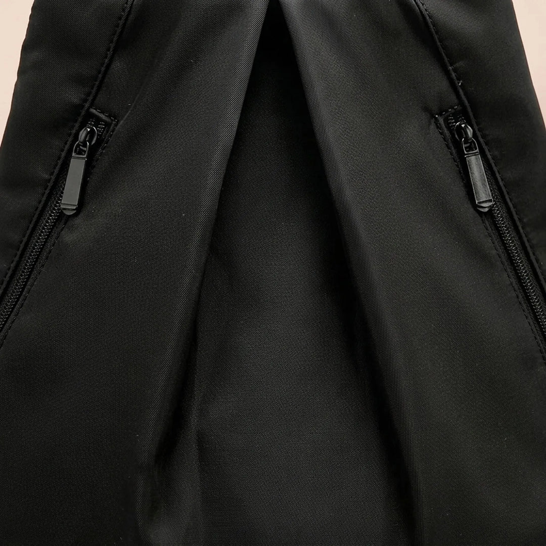 Sleek black polyester waterproof backpack, a durable and practical daypack for travel, swim, and hiking.