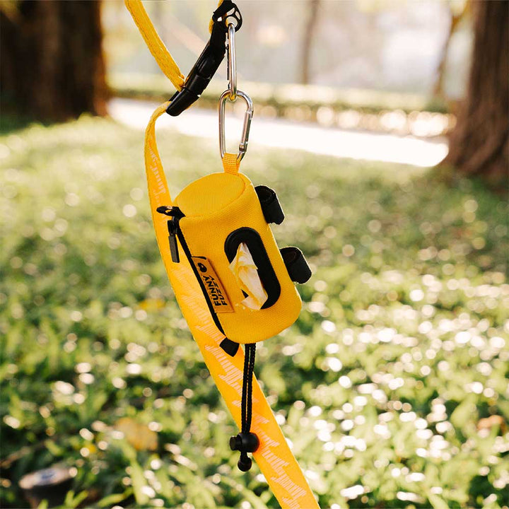 Close-up of waterproof pet waste bag dispenser with textured black finish and metal carabiner