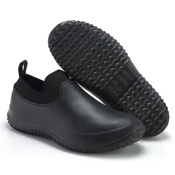 Person wearing unisex waterproof slip-resistant work shoes, providing comfort and protection in a wet environment.