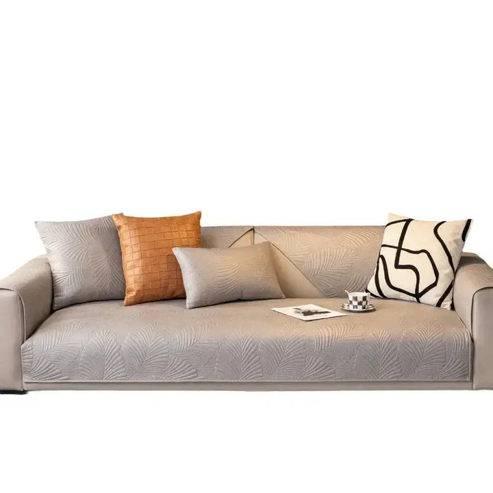 Lifestyle image of a pet relaxing on a protected sofa with a scratch-resistant cover