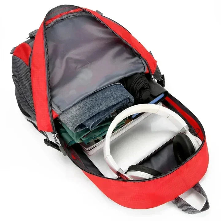 Front view of a black unisex waterproof travel backpack showing secure zippers & external pockets for quick access.