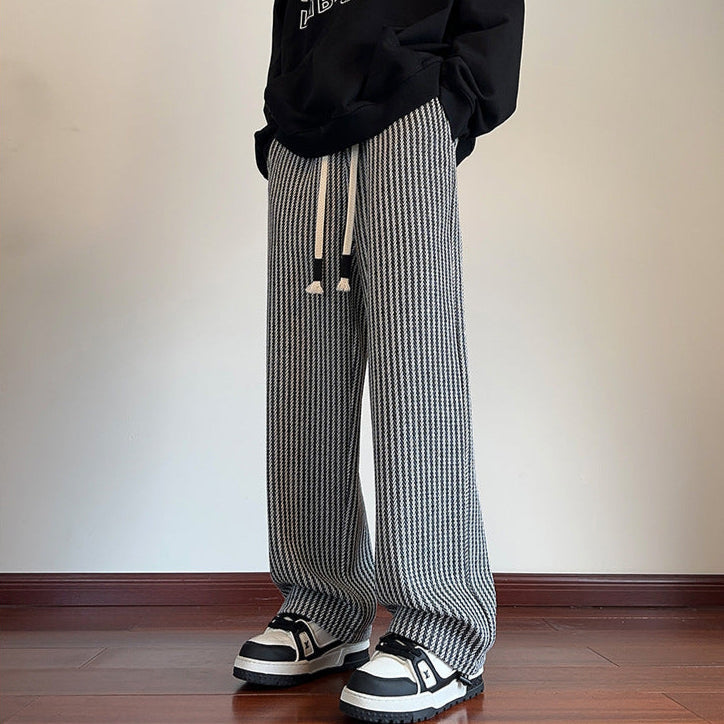 Comfortable unisex wide-leg sweatpants featuring a stylish herringbone pattern & adjustable drawstring, perfect for loungewear.