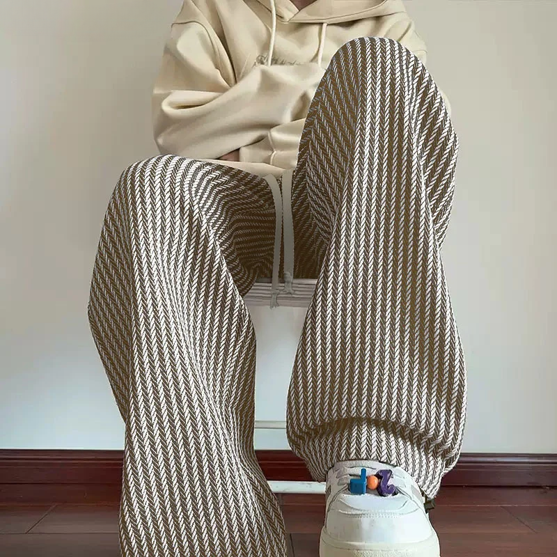Fashionable wide-leg herringbone sweatpants for unisex everyday wear. Relaxed fit casual pants with comfortable drawstring.