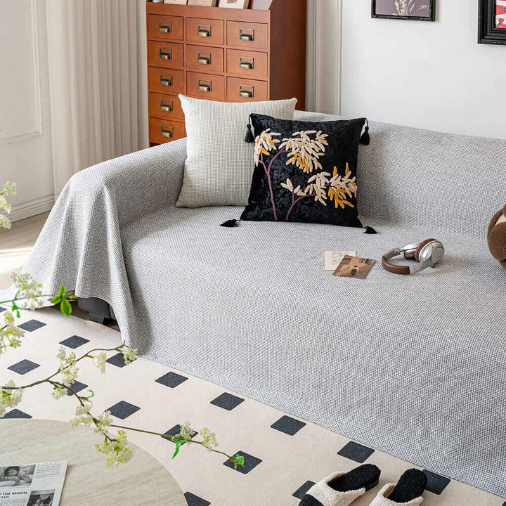 Full view of a living room sofa with a pet-friendly linen-look couch cover, enhancing home decor.