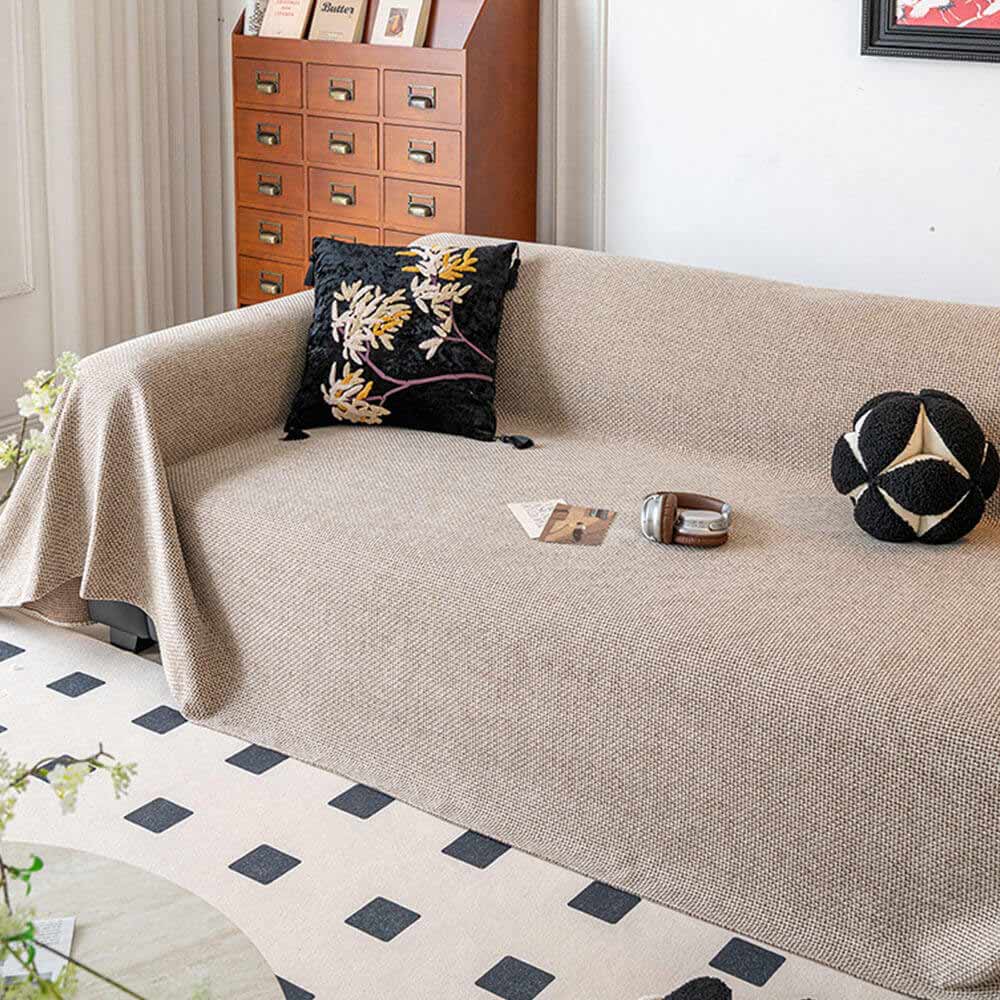 Reversible linen-look sofa throw in a light color, ideal for pet owners, scratch-resistant design.