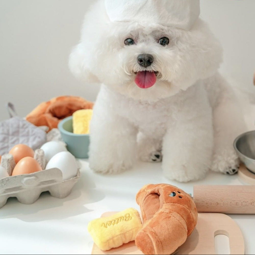 Plush croissant dog toy, yellow and soft, designed for engaging and interactive pet playtime.