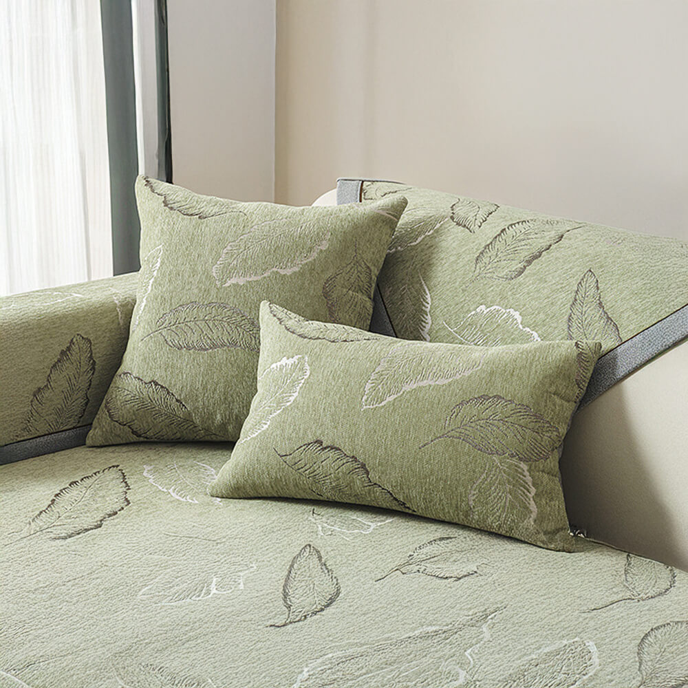 Close-up of chenille sofa slipcover displaying soft leaf texture and durable, non-slip backing.