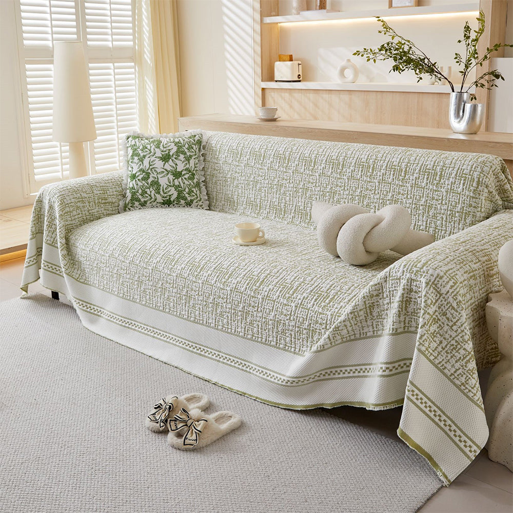 Ice silk sofa cover draped over a three-seater couch, offering cooling comfort for all seasons & home decor
