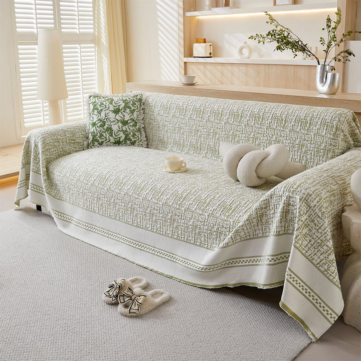 Ice silk sofa cover draped over a three-seater couch, offering cooling comfort for all seasons & home decor