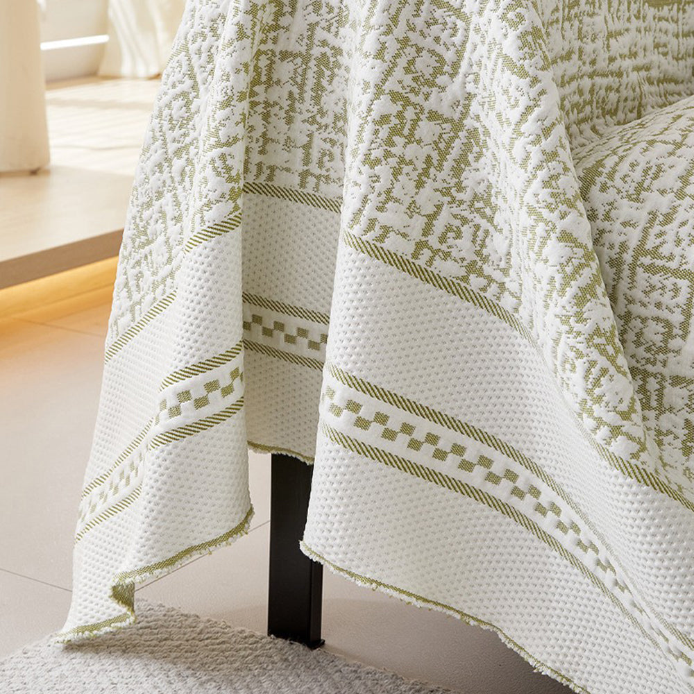 Family sitting comfortably on a couch with a universal ice silk cooling sofa cover, pet-friendly & durable