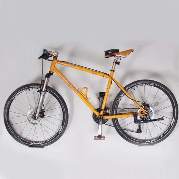 Bike holder for wall mounting. Durable heavy-duty rack for secure bicycle storage & space optimization.