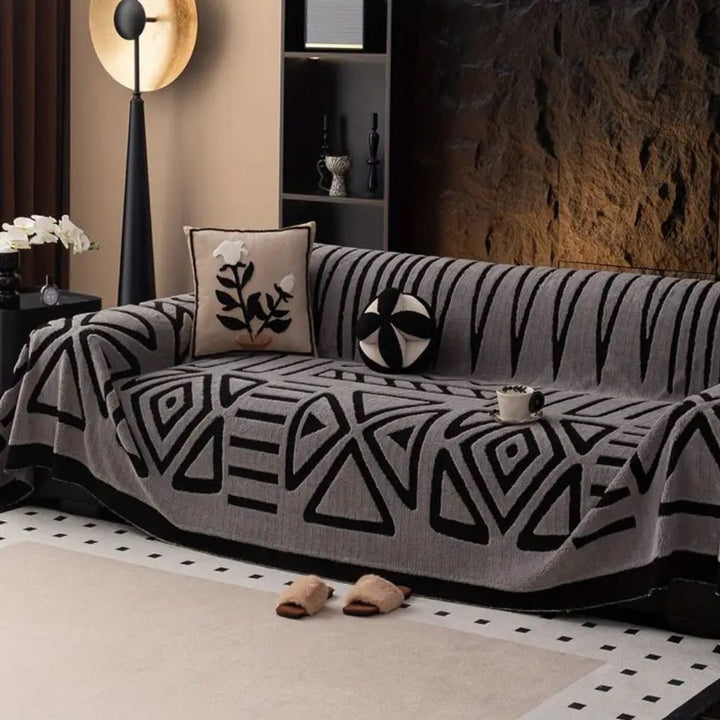 Non-slip Urban Maze sofa cover securely fitted on a living room couch, offering pet-friendly furniture protection.