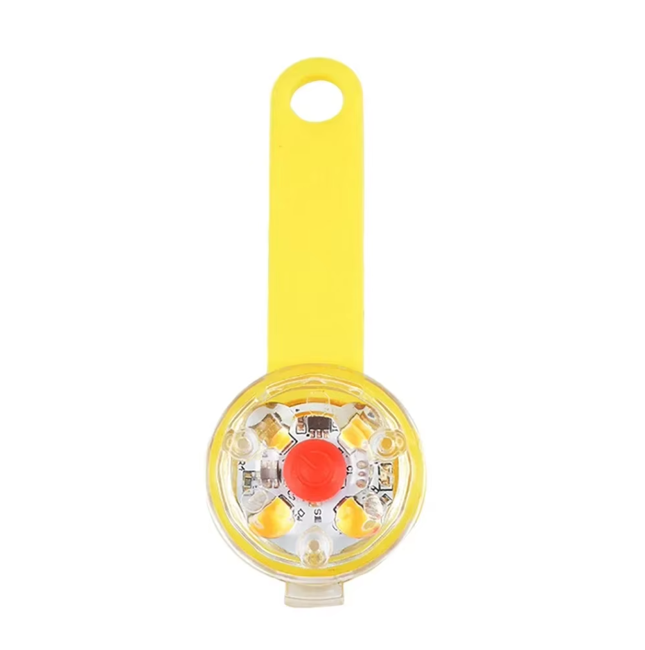 Pet night safety LED light, USB rechargeable, showing secure attachment to harness