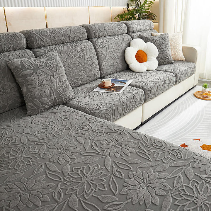 Side profile of a sofa with a snugly fit stretch velvet floral couch protector, durable design