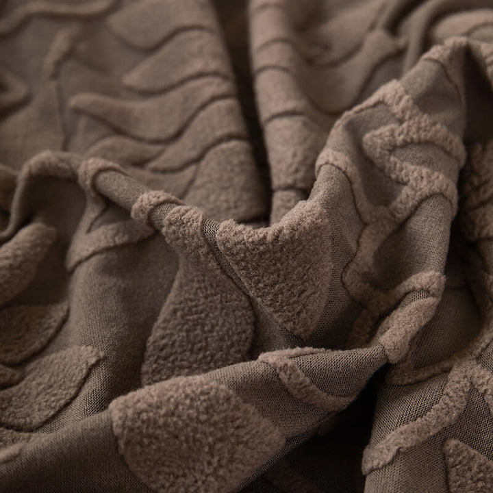 Corner of a couch with a fitted velvet floral slipcover, soft and stretchable fabric