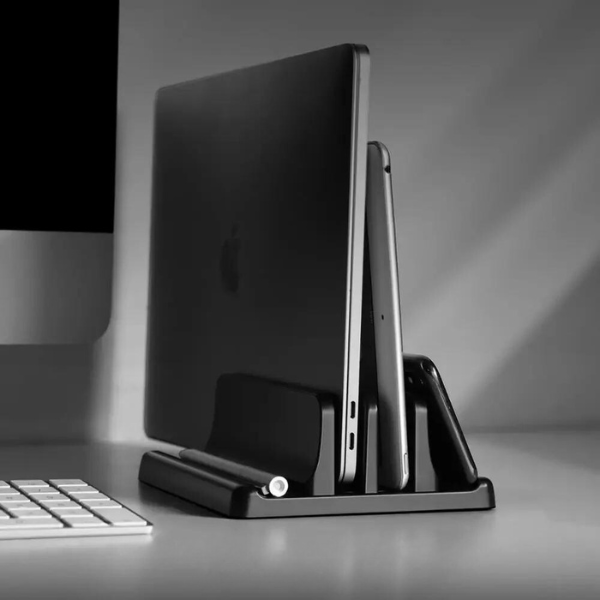 Vertical laptop desk stand in silver, saving space on your workstation. Perfect for notebooks and office organization.