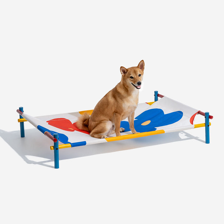 Pet furniture: elevated dog bed with a cheerful summer print fabric and robust aluminum support.